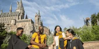 Universal Orlando Resort A family posing outside Hogwarts Castle in Universal Orlando Resort