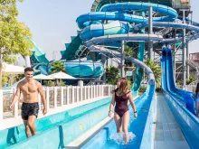 Couple coming off the Loop water slide at Laguna Waterpark Dubai