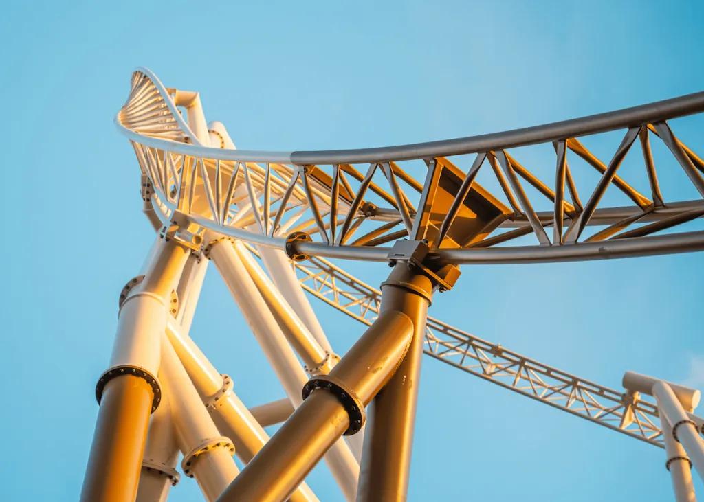 Hyperia at Thorpe Park Looking up at a golden coloured rollercoaster track in front of a clear blue sky