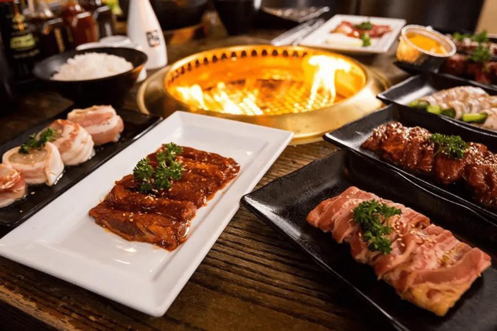 Dining in Orlando  Small firepit in centre of table with plates of food surrounding it.