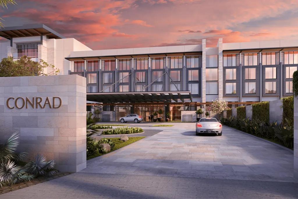 Conrad Orlando A sleek modern white building/ hotel with a large sign outside saying "CONRAD".