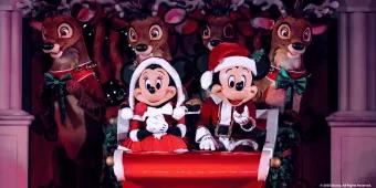 Mickey’s Most Merriest Celebration Mickey and Minnie in Santa outfits on a sleigh in front of reindeer