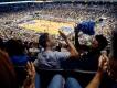 Orlando Magic Basketball Two friends high-fiving while watching an Orlando Magic game