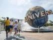Universal Orlando Resort A family walking in front of the Universal globe at Universal Orlando Resort