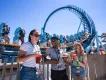 Seven Seas Food Festival at SeaWorld Orlando Three young adults stood in front of the Pipeline rollercoaster drinking cocktails and eating festival plates
