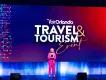 Visit Orlando Travel & Tourism Conference Visit Orlando Travel & Tourism Conference - woman speaking and announcing in a pink suit.