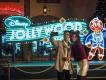 Disney Jollywood Nights at Disney's Hollywood Studios A couple taking a selfie in front of a neon sign for Disney Jollywood Nights