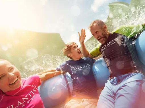 Family enjoying Aquaconda water slide at Aquaventure Dubai