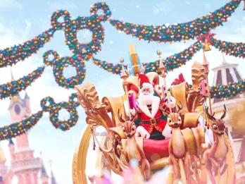 Santa on top of a parade float in front of Sleeping Beauty Castle at Disneyland Paris