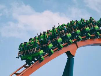 A green rollercoaster riding along the track 