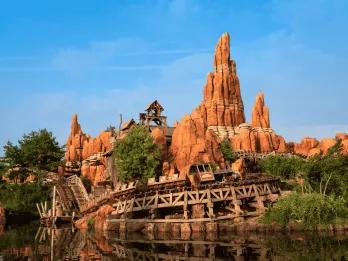 Looking over a river towards Big Thunder Mountain roller coaster